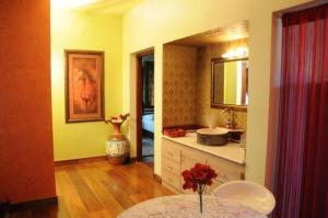 a bathroom with a table and a sink and a mirror at Malgudi Holidays in Kannur +19 photos