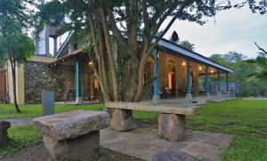 a stone bench sitting in front of a house at Stone Cottage in Kandy