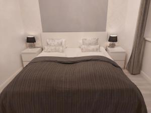 a bedroom with a large bed with two night stands at Apartmenthaus Franzis in Bad Gastein