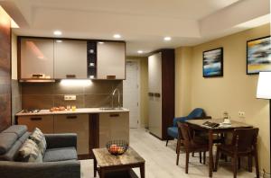 a living room and kitchen with a couch and a table at Residence Gudauri Hills in Gudauri