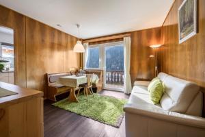 a living room with a couch and a table at Apartment Sciadules in Ortisei