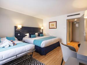 Кровать или кровати в номере Hotel Nice Riviera