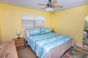 a bedroom with a bed and a ceiling fan at Island Wind Unit 303 in Fort Walton Beach