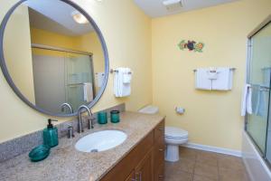 a bathroom with a sink and a mirror at Island Wind Unit 303 in Fort Walton Beach +16 photos