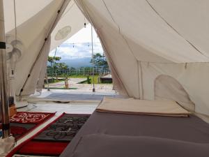 a tent with a bed in it with a view at Ciawitali Glamping in Cibitung 2
