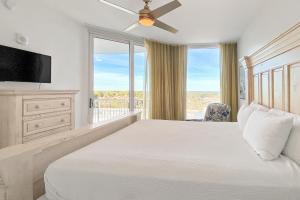 a bedroom with a bed and a large window at The Palms of Destin II in Destin
