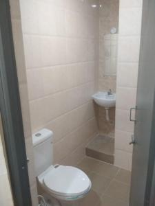 a bathroom with a toilet and a sink at Sri Abbirami Lodge in Kumbakonam