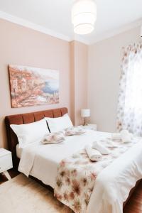 a white bedroom with two beds with white pillows at Best House, Ellinou Stratiotou, Ayia, Patra in Patra