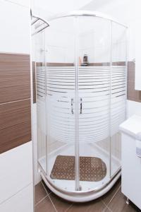 a shower with a glass enclosure in a bathroom at Best House, Ellinou Stratiotou, Ayia, Patra in Patra