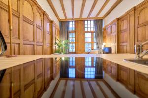 a large kitchen with wooden cabinets and a sink at Maison Grand Place 1BR 2 in Brussels +19 photos