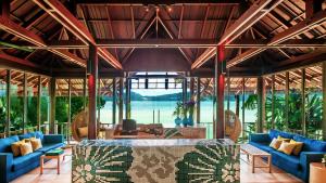 a living room with blue couches and a table at Amari Phuket in Patong Beach