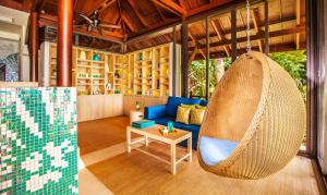 a room with a hammock in a house at Amari Phuket in Patong Beach