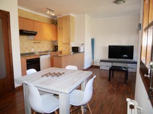 a kitchen and dining room with a table and chairs at Xarpell-Vacances Pirinenca in Encamp