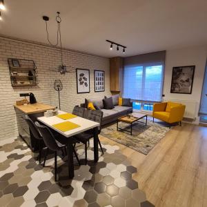 a living room with a couch and a table at City Apartment Anton Pann in Cluj-Napoca