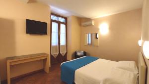 Postel nebo postele na pokoji v ubytování Hotel Rita Major