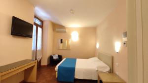 Postel nebo postele na pokoji v ubytování Hotel Rita Major