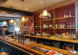 a bar in a pub with a lot of alcohol at The Fox in Much Wenlock