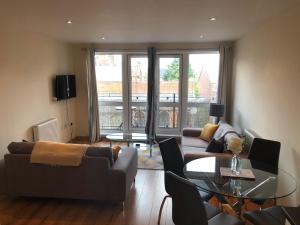 a living room with a couch and a table at Blue Sky Apartments@Guildford Town Centre in Guildford