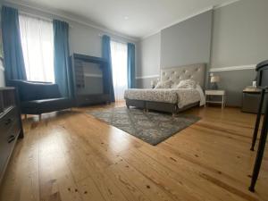 a living room with a couch and a television at Casa Saudade luxury rooms in Faro