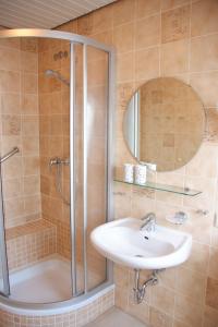 a bathroom with a shower and a sink at Haus Burmeister in Tinnum