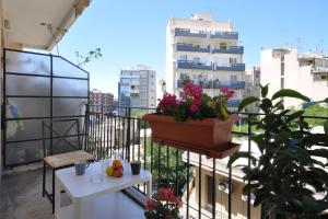 a balcony with a table and a plant on it at Nice Apartment Near City Center in Athens