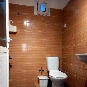 a bathroom with a toilet and a sink at WHITE STUDIOS in Himare