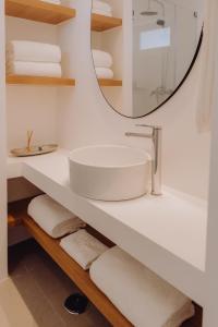a bathroom with a sink and a mirror at Casa Balaia 70 in Albufeira