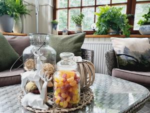 a glass table with a jar of fruit on it at Forsthaus Garz in Garz