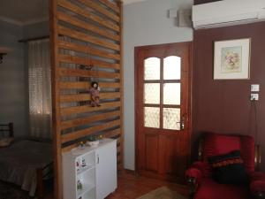 a living room with a wooden wall with a ladder at Helen's House Limenaria in Limenaria