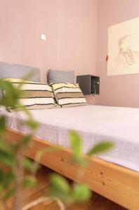 a bedroom with a bed with white sheets at Nice Apartment Near City Center in Athens