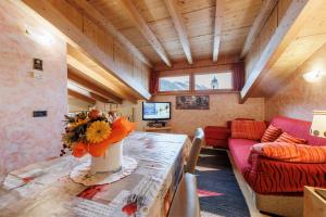 a living room with a table and a couch at Hotel San Rocco in Livigno