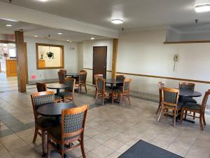 a waiting room with tables and chairs in a restaurant at Express Inn & suites in Decatur