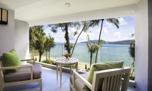 a living room with a view of the ocean at Amari Phuket in Patong Beach