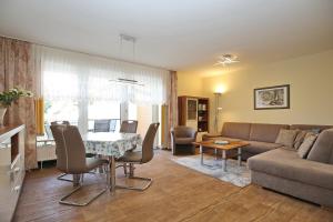 a living room with a couch and a table at Am Mariannenweg Wohnung 07 in Boltenhagen