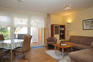 a living room with a couch and a table at Am Mariannenweg Wohnung 07 in Boltenhagen