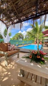 a resort with a pool and a couch and a table at Charming House in Albion with Shared Pool in Albion