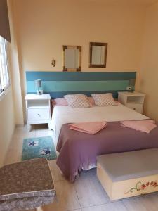 een slaapkamer met 2 bedden en een blauw hoofdeinde bij Apartamento Olaya in Candelaria