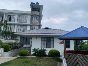 a house with a lighthouse on top of it at NOLINA BOUTIQUE HOMESTAY in Namchi