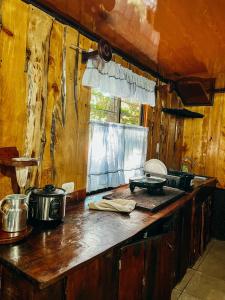 a kitchen counter with pots and pans on it at Cabaña Piqueza! in Poás +8 photos