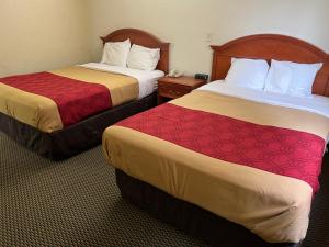 a hotel room with two beds and a phone at Express Inn & suites in Decatur