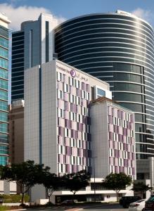 a large building in front of a large building at Premier Inn Dubai Barsha Heights in Dubai