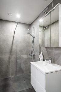 a bathroom with a white sink and a shower at Kaneder Hof - Self Check-in in Inchenhofen
