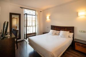Postel nebo postele na pokoji v ubytování Hotel Rincón del Conde