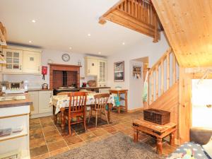 a kitchen and dining room with a table and chairs at Bogindour Cottage in Muir of Ord +19 photos