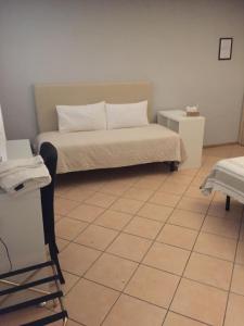 una camera con letto e pavimento piastrellato di Da Battista a Suzzara