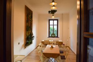a dining room with a table and chairs and a window at Penzion Betty in Okounov