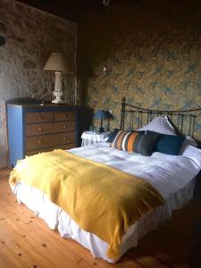 a bedroom with a large bed with a yellow blanket at Le Bouyssou in Cazes-Mondenard +32 photos