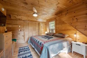 a bedroom with a bed in a log cabin at Log Home Retreat at Lake Winnipesaukee! in Meredith