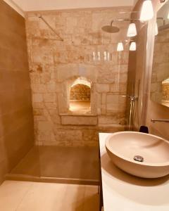 a bathroom with a sink and a fireplace at Casa d'Autore in Ostuni