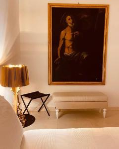 a living room with a painting on the wall and a couch at Casa d'Autore in Ostuni